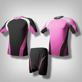 A pink soccer jersey with thick white lining along the shoulder to the under arm with black underneath the biceps and along the hip going downward from the sides. A black soccer jersey with thick white lining along the shoulder to the under arm with pink underneath the biceps and along the hip going downward from the sides. One black short with pink lining.